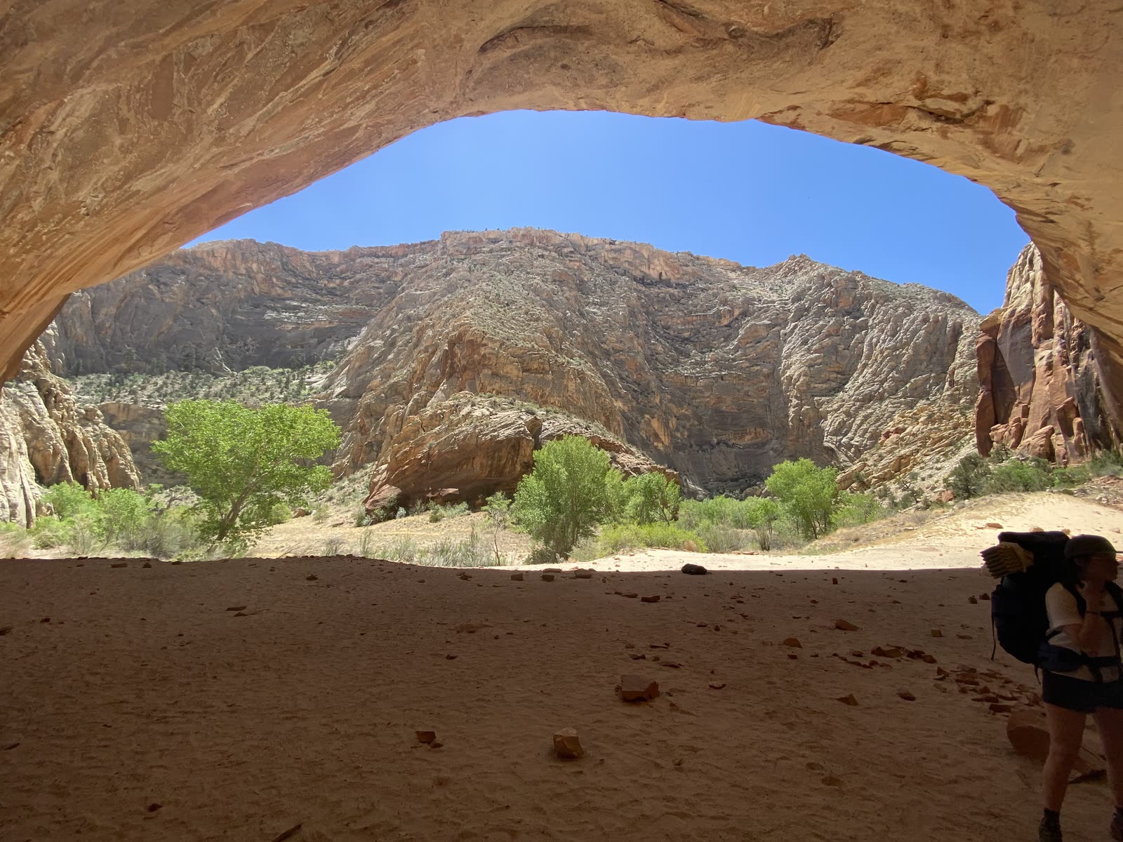 Sandstone arch framing desert rock and open blue sky